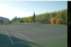 una pista de tenis con una red encima en Agréable maisonnette de 45m2, en Gallargues-le-Montueux