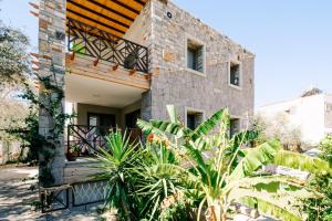 a brick house with plants in front of it at Chic Flat w Balcony 3 min to Beach in Bodrum in Bodrum City