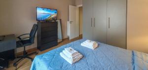 a bedroom with a bed with two towels on it at Acropolis Terrace View Apartment in Athens