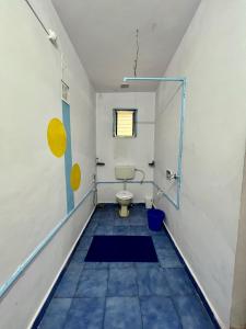 a bathroom with a toilet and a window at Endless Blue Hostel 