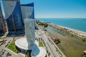 an aerial view of a building next to a beach at Alliance Palace Aparthotel in Batumi