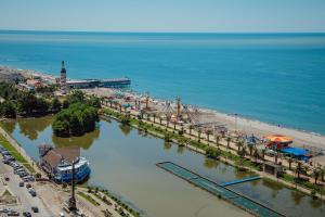 an aerial view of a beach with a pier at Alliance Palace Aparthotel in Batumi