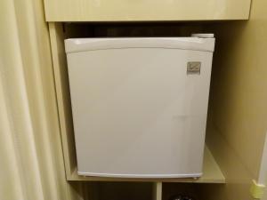 einen weißen Kühlschrank in einer Ecke eines Zimmers in der Unterkunft Amour Rouge Suite (Adults Only) in Galaţi