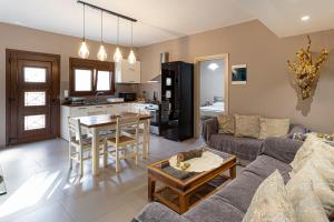 a living room with a couch and a table at Irinis Apartments Karfas, Chios in Chios