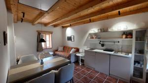 a kitchen and living room with a table and chairs at Vila Milenovic Rajacke Pivnice in Rajac