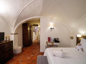 a bedroom with a bed with a teddy bear sitting on it at Canal View Hotel Ter Brughe by CW Hotel Collection in Bruges