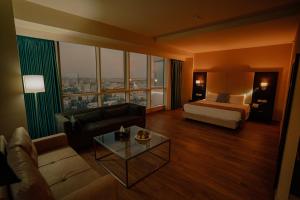 a large hotel room with a bed and a couch at Carmel Hotel in Ramallah