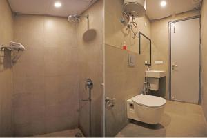 a bathroom with a shower with a toilet and a sink at Hotel Silver Velvet "Britannia Chowk- Couple Friendly Local ID Accepted" in New Delhi