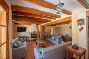 a living room with couches and a fireplace at Casa Rural Cal Martí in El Pla de Manlleu