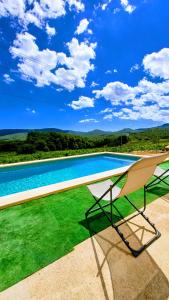a swimming pool on the roof of a house at Casa Rural Cal Martí in El Pla de Manlleu
