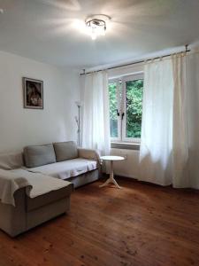 a living room with a couch and a window at Wohnung am Waldrand in Melle