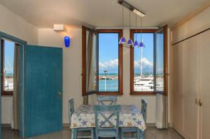 a dining room with a table and a view of the ocean at L'incanto Di Boccadarno in Marina di Pisa