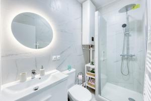 a white bathroom with a shower and a sink at Bundle Famille Max - 12 personnes in La Courneuve