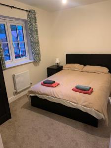 a bedroom with a bed with two towels on it at Sea side family rest and holiday in Colwyn Bay