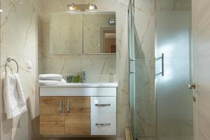 a bathroom with a sink and a shower at Irinis Apartments Karfas, Chios in Chios