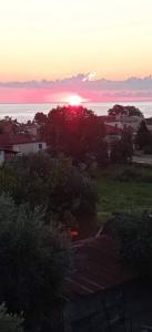 a sunset over the ocean with the sun in the sky at ANASTASIA ROOMS in Stratónion