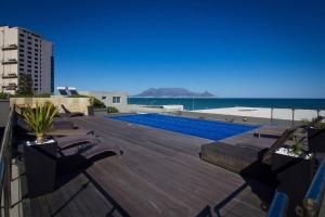 a swimming pool on the roof of a building at 801 Infinity 2 Bedroom Beachfront Apartment in Cape Town