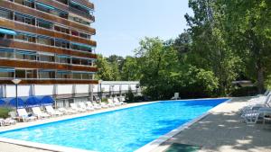 a large swimming pool next to a building at Neptun 501 in Balatonföldvár