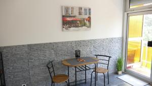 a table and chairs in a room with a brick wall at Neptun 501 in Balatonföldvár
