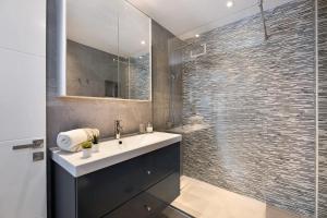 a bathroom with a sink and a glass shower at Tranquilidad 300m to beach freewifi in Puerto del Carmen +14 photos
