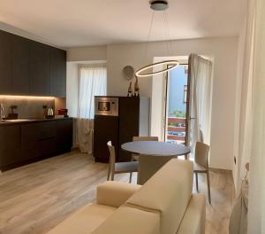 a living room and kitchen with a table and a couch at San Rocco Apartments in Riva del Garda
