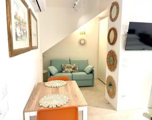 a living room with a couch and a table at David suite in centro storico in Caorle