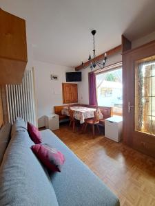 a living room with a couch and a table at Appartamenti Home Service in Arabba