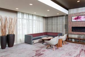 a lobby with a couch and a table and chairs at Courtyard Louisville Downtown in Louisville