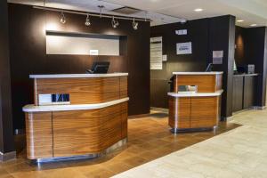 a lobby with two reception desks in a building at Courtyard by Marriott Cleveland Willoughby in Willoughby