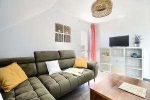 a living room with a couch and a table at Apartment NeWA in Gąski