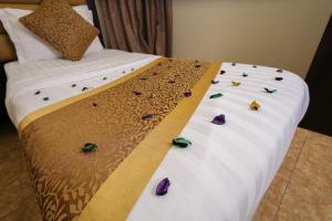 a bed with some flowers on the side of it at Lina Park 2 in Dammam