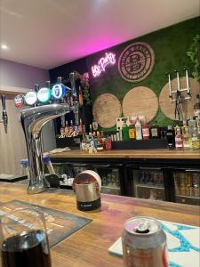 a bar with a wooden counter with a counter top at The Brig & Barrel hotel in Buckie