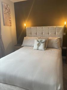 a large white bed with a pillow on it at The Brig & Barrel hotel in Buckie