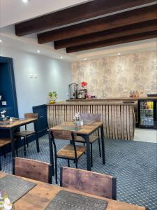 a restaurant with wooden tables and chairs and a counter at The Brig & Barrel hotel in Buckie
