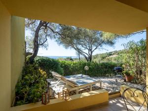 a view of a patio with a table and chairs at Casa Flaminia Villasimius in Villasimius