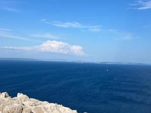 a view of the ocean from the top of a cliff at Villa I Karma in Tisno