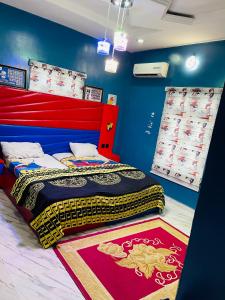 a bedroom with a bed and a rug on the floor at Dsmarts apartments in Benin City