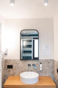 a bathroom with a sink and a mirror at Hotel SALEI in Ghigo