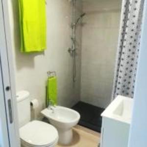 a bathroom with a white toilet and a sink at Studio with shared pool enclosed garden and wifi at Monchique in Monchique