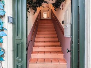 a staircase in a house with a green door at Aparthotel AMMI Vieux Nice in Nice