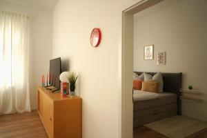 a bedroom with a bed and a clock on the wall at Apartment Mira in Senftenberg