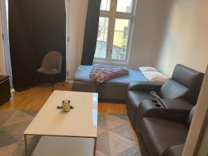 a living room with a couch and a table at Dali Oslo center apartment in Oslo