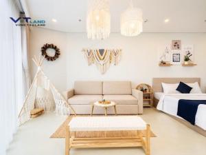 - un salon avec un lit et un canapé dans l'établissement The Song Vung Tau Homestay - VTLand, à Vung Tau
