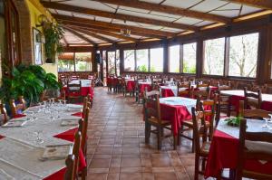 a dining room with tables and chairs with red tablecloths at Villa delle Muse da Imma in Palinuro +239 photos