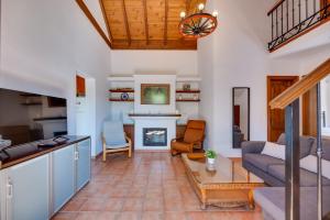 a living room with a couch and a fireplace at Casa rural entre Ojén y Marbella in Ojén