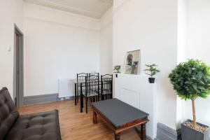 a living room with a couch and a table at 2A - Bright & Airy 2 Bed Flat - 20 Mins to Central in London