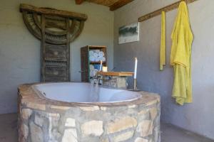 a bathroom with a bath tub made out of a wooden stump at Thorn & Feather, Vermaaklikheid in Vermaaklikheid +69 photos
