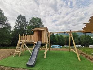 a wooden playground with a slide and a swing at Beskidzka Stodoła przy szlaku z pięknym widokiem in Złatna
