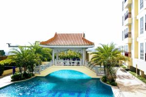 a gazebo over a swimming pool in a building at Lucky Tower Residence 2BR Top Floor Condo in Jakarta