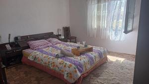 a bedroom with a large bed with a table on it at House Stefanovic 